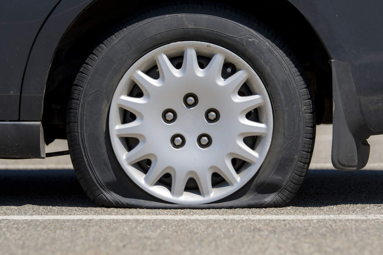 Technician changing a flat tyre